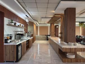 a large kitchen with wooden cabinets and a counter top at Al Jawahiri Hotel in Erbil