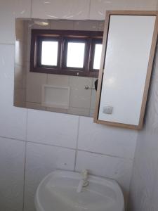 a bathroom with a sink and a mirror at Casario in Florianópolis +9 photos