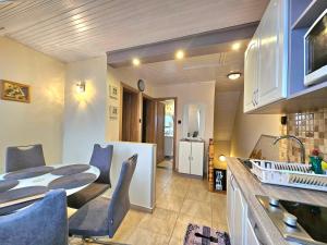 a kitchen and dining room with a table and chairs at Apartman Siesta Bük - Bükfürdő in Bük