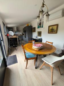 a kitchen and dining room with a table and chairs at Penn Ar Bed in Paimpol