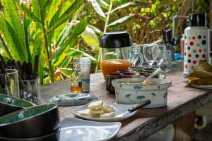 a wooden table with food and glasses on it at Casa Peñones in Murillo