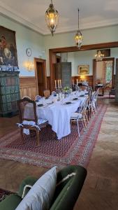 a large dining room with a long table and chairs at Castle Of Saint Germain Des Rives in Saint-Germain-des-Rives