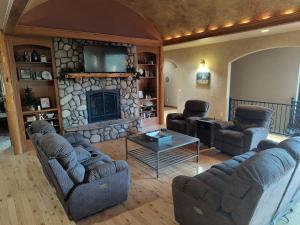 a living room with couches and a stone fireplace at Cherry on top lodge in Custer