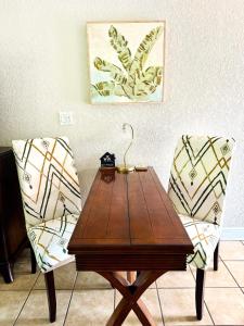a wooden table and two chairs with a lamp on it at Condo in Waterfront Resort with Balcony Close to Beaches Free Bikes in Dunedin