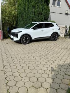 a white car parked in a driveway at Komfortný apartmán s bazénom a súkromným parkoviskom - 24h self check-in in Banská Bystrica