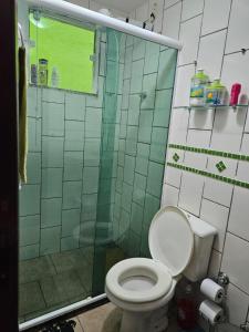 a bathroom with a toilet and a glass shower at Paraíso Ibicui in Mangaratiba +13 photos