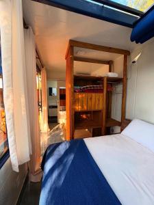 a bedroom with a bed and a wooden cabinet at Santuário Panacéia in Piracaia