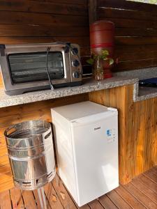 a microwave and a toaster oven sitting on a counter at Santuário Panacéia in Piracaia