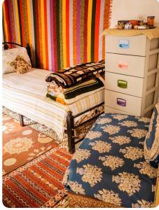 a bedroom with a dresser and a bed with a rug at Maison Soulaîmi in Fès