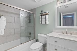 a bathroom with a toilet and a sink and a shower at Sea La Vie - Pelican Beach Resort in Destin