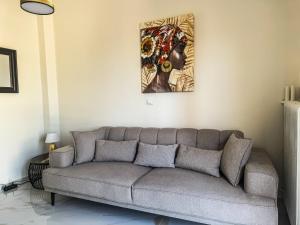 a couch in a living room with a painting on the wall at The Spot in Xanthi