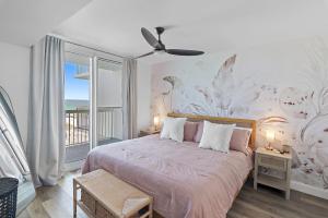 a bedroom with a bed with a flower wall at Sea La Vie - Pelican Beach Resort in Destin