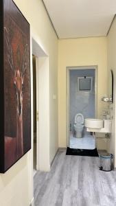 a bathroom with a toilet and a painting of a deer at الغزال in Al Hofuf +8 photos