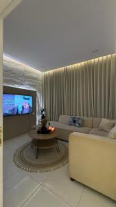 a living room with a couch and a tv at الغزال in Al Hofuf