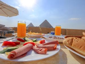a plate of food on a table with food at Alex Pyramids View Inn in Giza