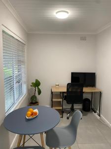 an office with a table and chairs and a desk at Garden flat Durbanville - with Office, WiFi and secure gated parking in Eversdal +5 photos