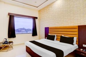 Postel nebo postele na pokoji v ubytování Hotel O Palm Bliss Hotels & Resorts