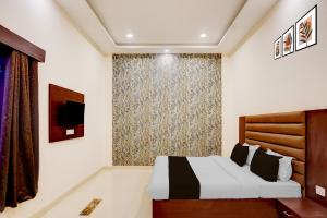 Postel nebo postele na pokoji v ubytování Hotel O Palm Bliss Hotels & Resorts + 22 fotografií