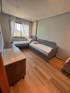 a bedroom with a bed and a large window at Blue Beach Sidi Rahal in Casablanca