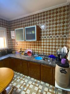 a kitchen with a sink and a counter top at Bellahcen house in Nador