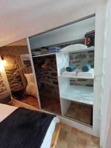 a room with a bed and some shelves at Casa Aninhas in Sabrosa