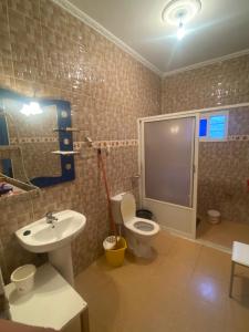 a bathroom with a toilet and a sink at Bellahcen house in Nador