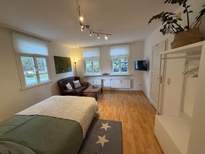 a bedroom with a bed and a living room at Ferienwohnung Altes Gut Kenkhausen in Wermelskirchen