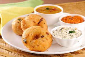 a plate of food with biscuits and dip and dips at Super Hotel O Infosys Thoraipakkam in Chennai