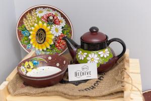 a tea pot and a bowl of milk on a table at Beehive Hotel in Odesa