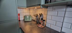 a kitchen counter with a toaster and utensils at Amazing Central Windsor Flat Contractors welcome in Windsor
