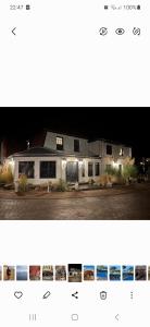 a picture of a white house with lights at Haylees Hus 2 in Kellenhusen