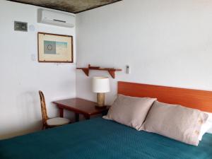 En eller flere senge i et værelse på Casa Angra dos Reis