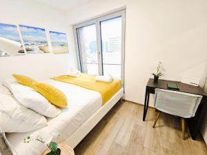 ルクセンブルクにあるLuxury 1 BR flat with parkingのベッド、机、窓のある寝室