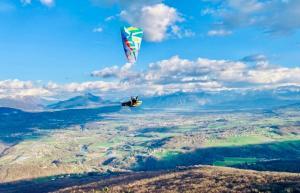 a person is flying a kite in the sky at T2 Cozy au Centre 4 Personnes RochExpo Train Express Annecy Genève Evian in La Roche-sur-Foron