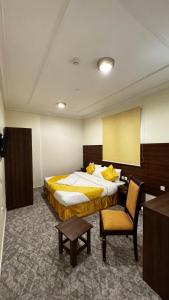 a hotel room with a large bed and a chair at فندق مضياف in Makkah