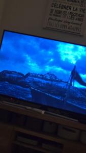 a television with a blue screen with a picture at Villa Piscine Juvignac 34 in Juvignac