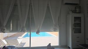 a window with a view of a swimming pool at Villa Piscine Juvignac 34 in Juvignac