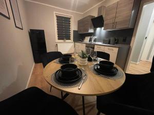 a wooden table in a small kitchen with a dining room at Fundis Apartment am Schloss in Bad Harzburg +2 photos