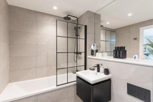 a bathroom with a sink and a shower at 2 Bed Apartment, in the heart of Manchester City Centre! 7 mins walk from Piccadilly Station! in Manchester