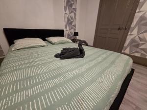 a stuffed animal is sitting on a bed at Maison du bonheur in Montier-en-Der +1 photo