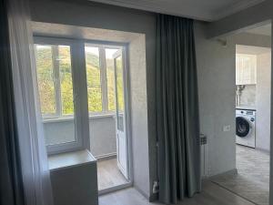 a room with a sliding glass door and a window at Njoy in Jermuk