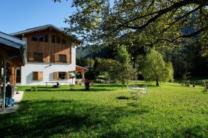 a house in a yard with a green lawn at Pur Mountain View Flat in Ledro
