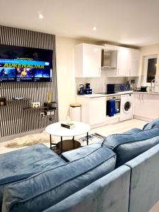 a living room with a blue couch and a table at The Burleigh palace in Cambridge