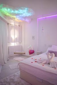 a bedroom with a bed with a rainbow ceiling at Suite romantique avec balnéo près de Vannes - L'instant suspendu in Questembert +33 photos