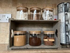 a shelf with many different types of food at Windsor Castle amazing Cottage in Windsor