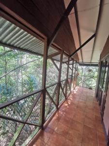 a view from the inside of a room with windows at Cabaña AMOTO in Turrialba