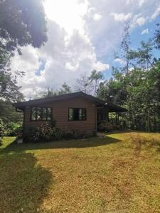 a house with a yard in front of it at Cabaña AMOTO in Turrialba