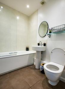 a bathroom with a tub and a toilet and a sink at House in the heart of Reading Contractors welcome in Reading