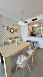 a kitchen and dining room with a wooden table and chairs at Casa del Sol in Altea +30 photos