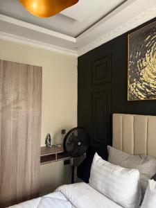 a bedroom with a bed and a ceiling fan at Dream Property Solutions-Silverest in Lusaka